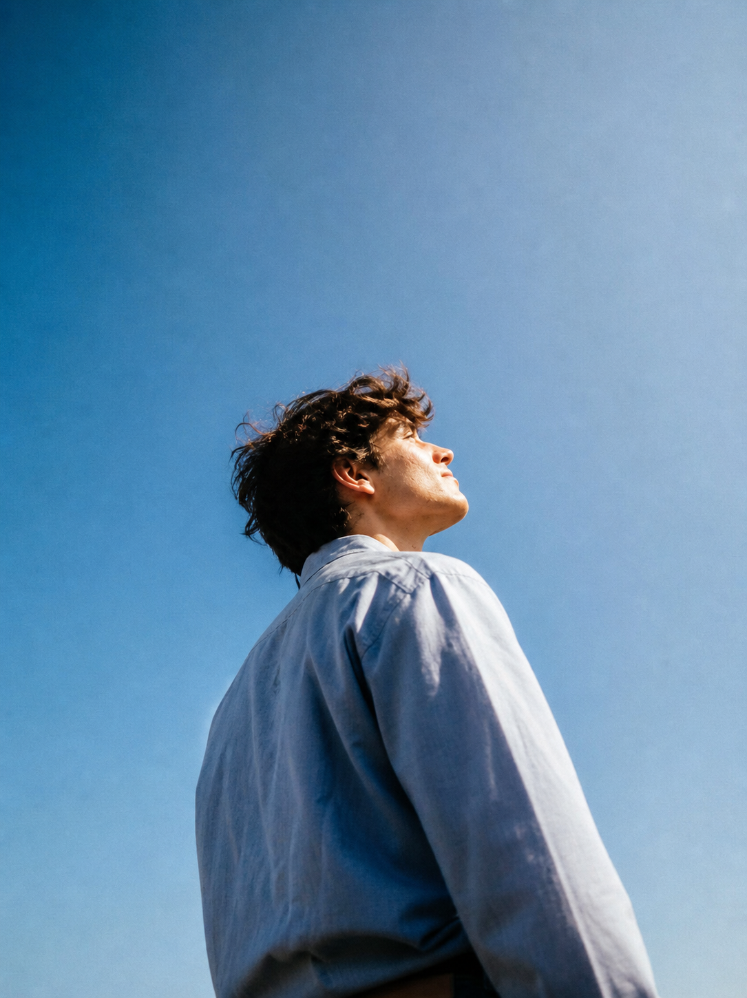 Founder looking up at a clear blue sky